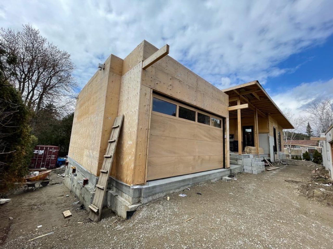 Contemporary custom home under construction with angular massing and black windows