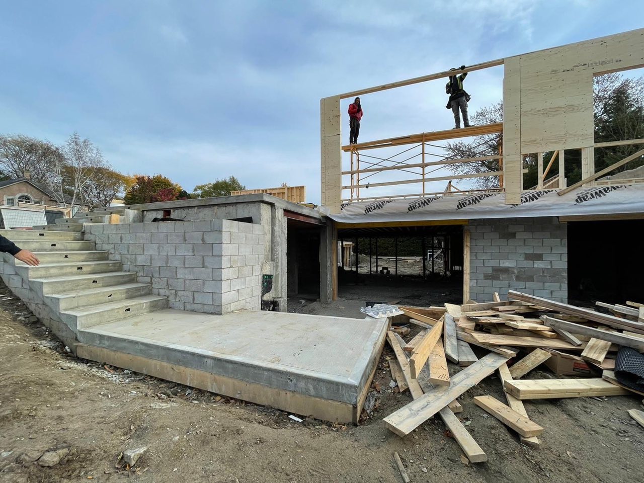 Custom home being framed, with a crew setting the second-storey structure